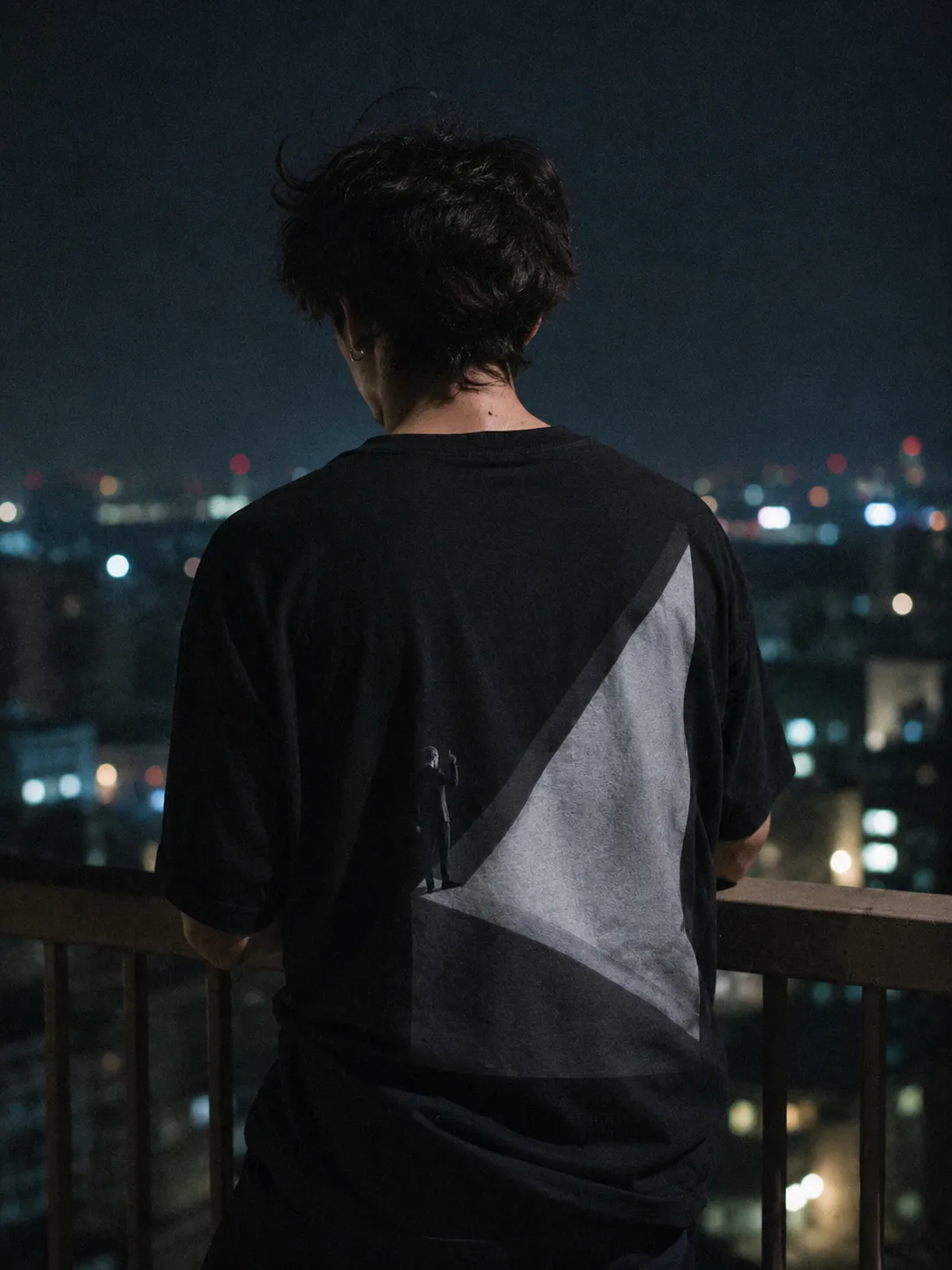 The VERTIGO II tee worn, the print large across the back.