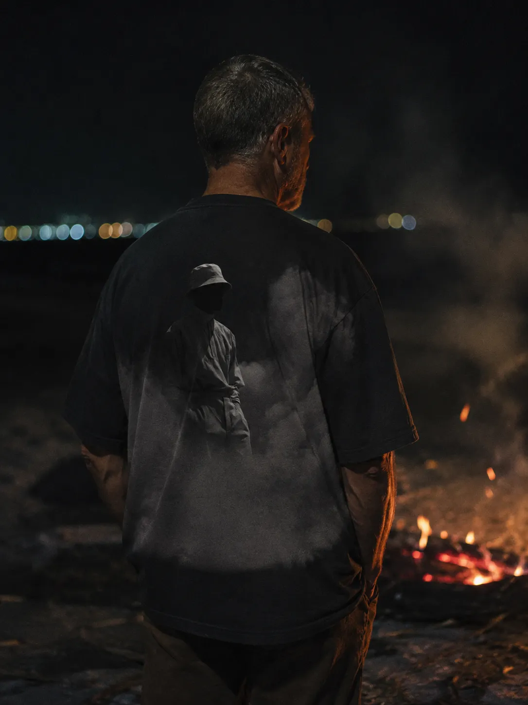The EMBER tee worn, the print large across the back.